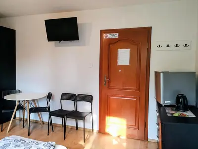 a room with a table and chairs and a door at Kwatery pracownicze Kęty Zielona in Kęty