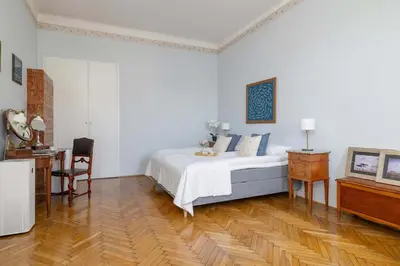 a white bedroom with a bed and a desk at Uroczy Przestronny Apartament w Krakowie by Noclegi Renters in Kraków