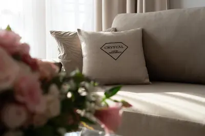 a couch with a pillow with an exesisarmaarmaarmaarmaarmaarmaarma at Crystal Luxury Apartments Rakowicka in Kraków