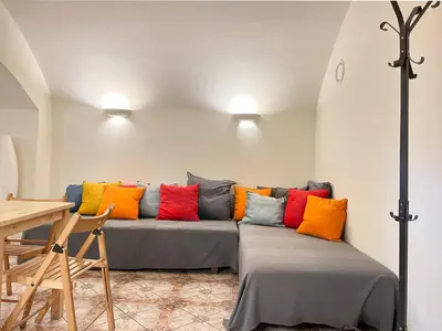 a living room with a couch with colorful pillows at Apartment for 12 guests in city center in Kraków