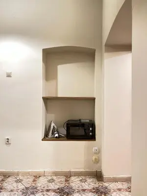a microwave sitting on a shelf in a room at Apartment for 12 guests in city center in Kraków