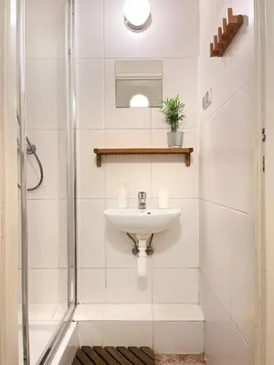 a bathroom with a sink and a shower at Apartment for 12 guests in city center in Kraków