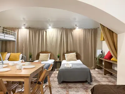 a room with two beds and a table and chairs at Apartment for 12 guests in city center in Kraków