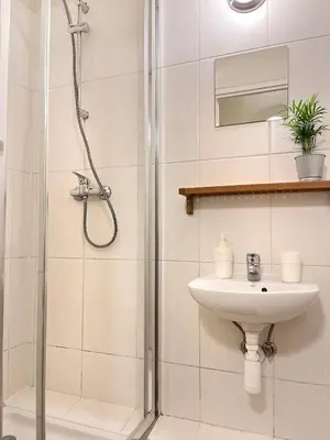 a bathroom with a shower and a sink at Apartment for 12 guests in city center in Kraków