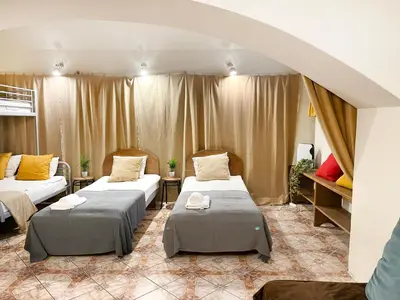 a room with two beds in a room with curtains at Apartment for 12 guests in city center in Kraków