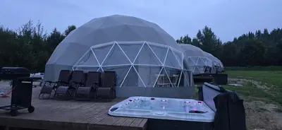 a large dome tent with chairs and a table at Aqua Glamp in Jaszczurowa