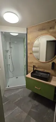 a bathroom with a sink and a mirror and a shower at Aqua Glamp in Jaszczurowa