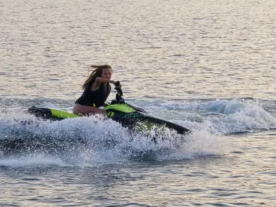 a woman riding a jet ski in the water at Aqua Glamp in Jaszczurowa