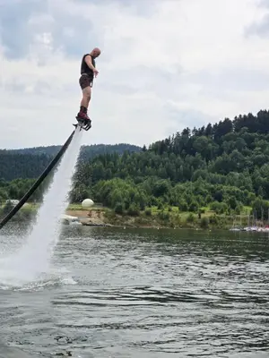 a man is on a board in the water at Aqua Glamp in Jaszczurowa