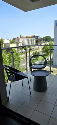 two chairs and a bench on a balcony at Apartament w centrum miasta, bezpłatny parking in Kraków