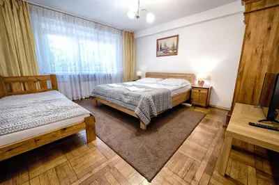 a bedroom with two beds and a window at Bagry Rooms in Kraków