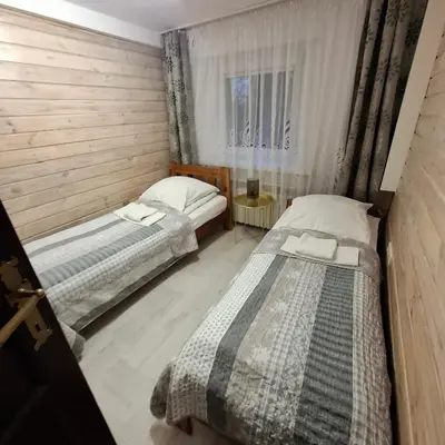 a bedroom with two beds and a window at Bagry Rooms in Kraków