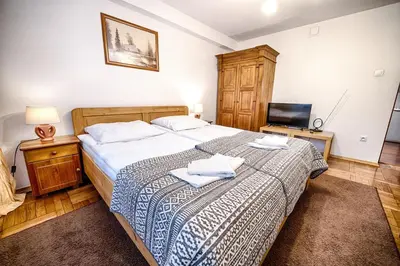 a bedroom with a bed with two towels on it at Bagry Rooms in Kraków