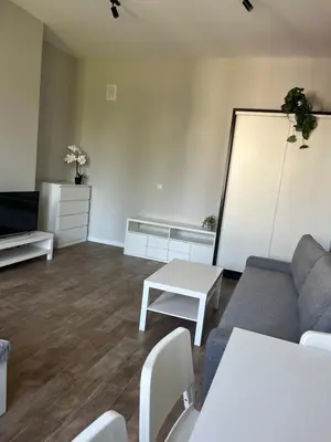 a living room with a couch and a table at Płaszowska Apartment in Kraków