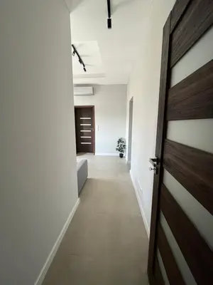 an empty hallway with a door in a room at Płaszowska Apartment in Kraków