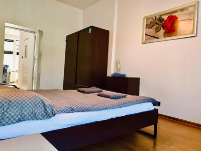 a bedroom with a bed and a cabinet with two towels on it at Apartament w centrum in Kraków