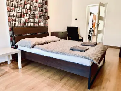 a bedroom with a bed and a large book wall at Apartament w centrum in Kraków