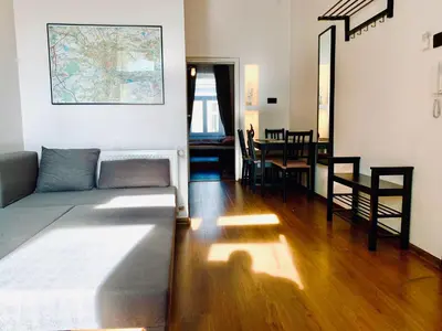 a living room with a couch and a dining room at Apartament w centrum in Kraków