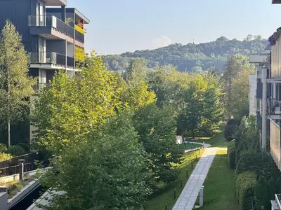 a street in a city with buildings and trees at Family Apartment Krakow Błonia in Kraków