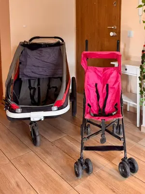 two strollers sitting on the floor in a room at Family Apartment Krakow Błonia in Kraków