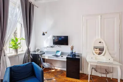 a room with a desk with a computer and a mirror at Malila Premium Aparthotel Sebastiana 20 Old Town in Kraków