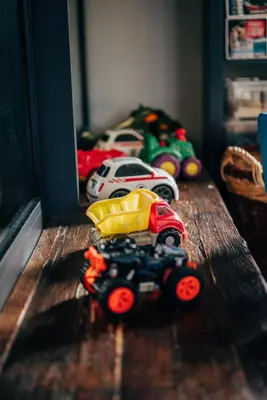 a wooden table with toy cars on top of it at Hotel Szary Residence in Michałowice