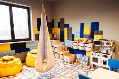 a play room with a hammock and a kitchen at Hotel Szary Residence in Michałowice