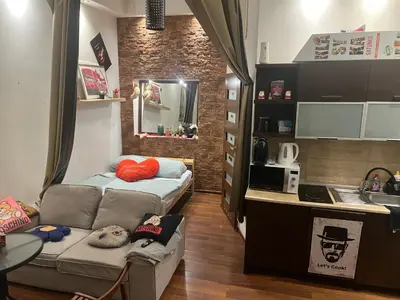 a small room with a bed and a kitchen at Lets go in Kraków