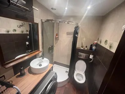 a small bathroom with a toilet and a sink at Lets go in Kraków