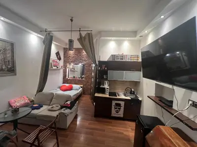 a small living room with a couch and a table at Lets go in Kraków