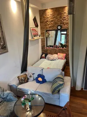 a living room with a couch and a mirror at Lets go in Kraków