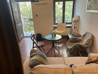 a living room with a couch and a table at Lets go in Kraków