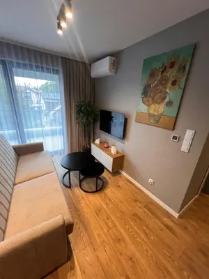 a living room with a couch and a table at Apartament Dominikanów 28m36 in Kraków