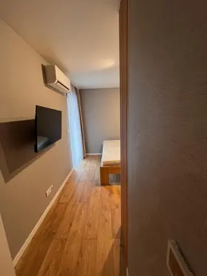 a small room with a bed and a door to a bedroom at Apartament Dominikanów 28m36 in Kraków