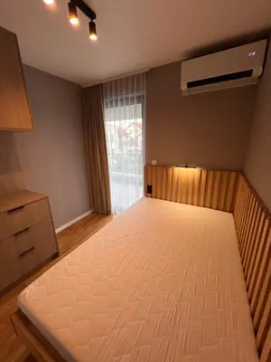 a bedroom with a large white bed with a window at Apartament Dominikanów 28m36 in Kraków