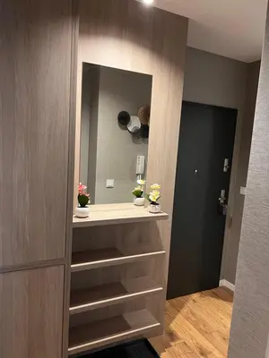 a dressing room with a large mirror and shelves at Apartament Dominikanów 28m36 in Kraków