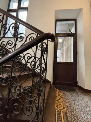 a staircase leading to a door in a building at Przytulne mieszkania na wynajem in Kraków