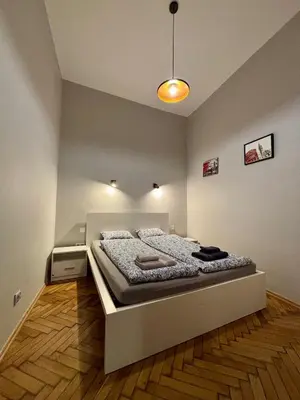 a bedroom with a large bed in a room at Przytulne mieszkania na wynajem in Kraków
