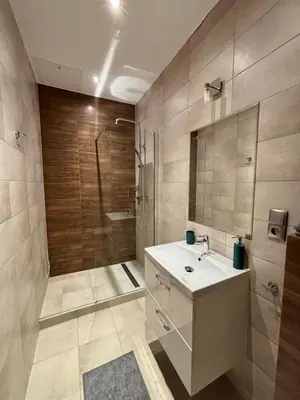 a bathroom with a shower and a sink and a tub at Przytulne mieszkania na wynajem in Kraków