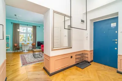a hallway with a blue door and a living room at Kraków Dębniki - Vistula River & Parks nearby in Kraków