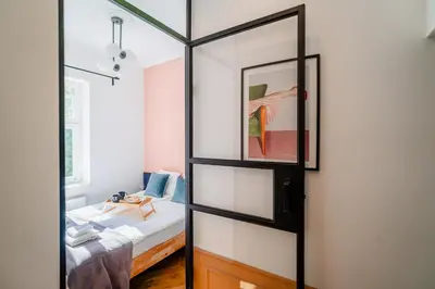 a bedroom with a mirror and a bed in it at Kraków Dębniki - Vistula River & Parks nearby in Kraków