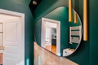 a mirror in a room with a green wall at Kraków Dębniki - Vistula River & Parks nearby in Kraków