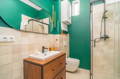 a bathroom with a sink and a toilet and a mirror at Kraków Dębniki - Vistula River & Parks nearby in Kraków