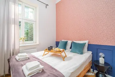 a bedroom with a bed with a table on it at Kraków Dębniki - Vistula River & Parks nearby in Kraków