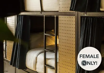 a bunk bed with a ladder in a room at dreamfactory - Hostel Krakow in Kraków