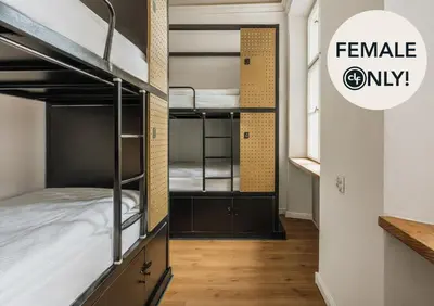 a room with bunk beds and a sign that reads female only at dreamfactory - Hostel Krakow in Kraków