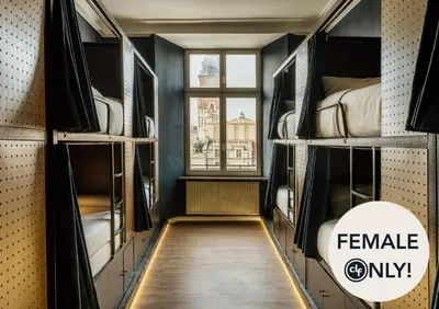 a room with bunk beds with a window at dreamfactory - Hostel Krakow in Kraków