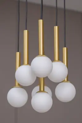 a bunch of gold and white lights hanging from a ceiling at Modern Prestige Apartment with Parking in Kraków by Noclegi Renters in Kraków