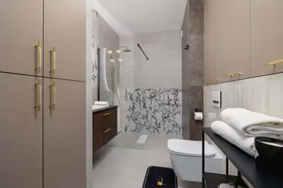 a bathroom with a toilet and a shower at Modern Prestige Apartment with Parking in Kraków by Noclegi Renters in Kraków