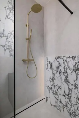 a shower with a gold shower head in a bathroom at Modern Prestige Apartment with Parking in Kraków by Noclegi Renters in Kraków